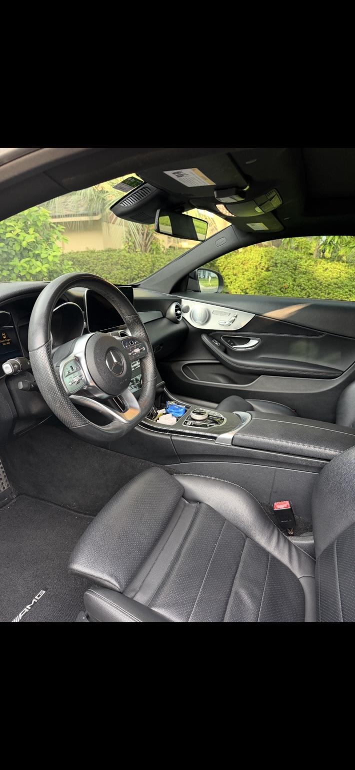 Mercedes-AMG interior with cleaned black leather seats and conditioned steering wheel