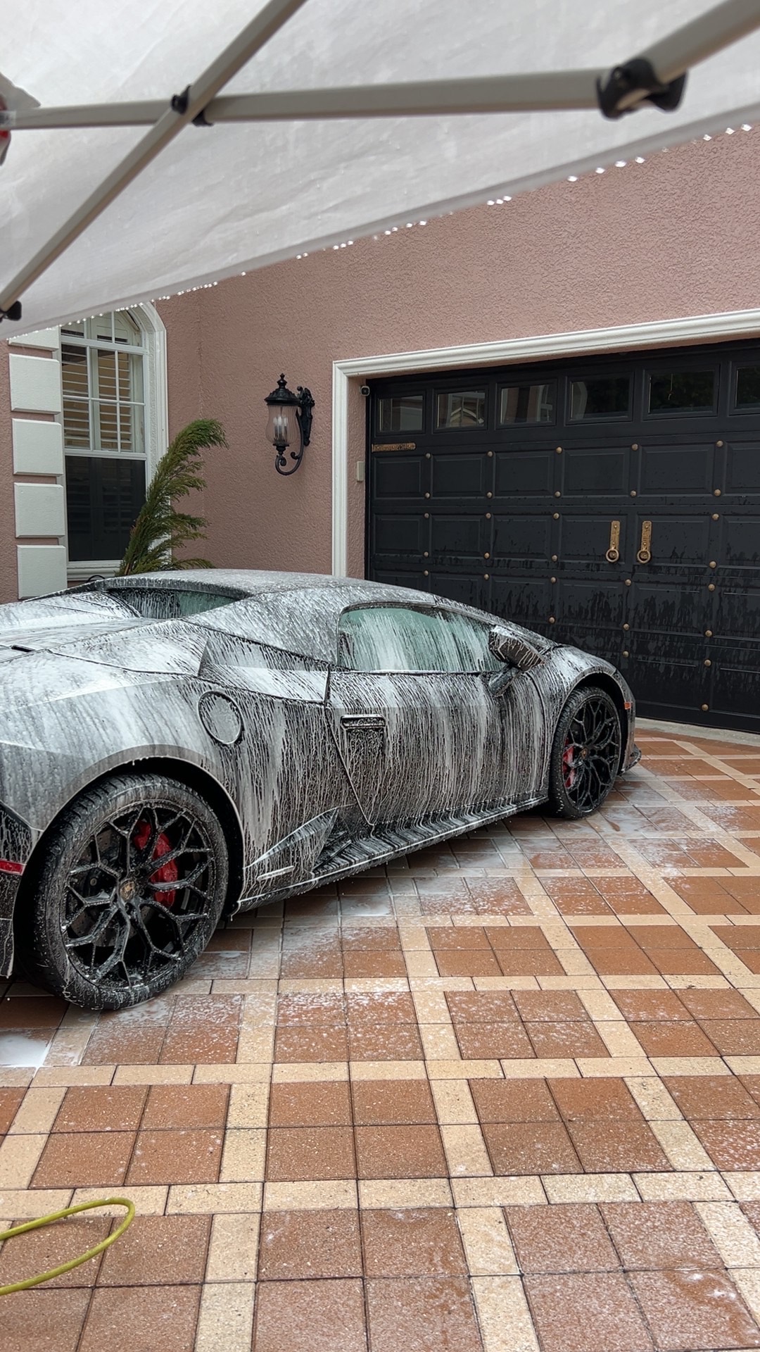 Lamborghini Huracán covered in white wash foam during a hand wash